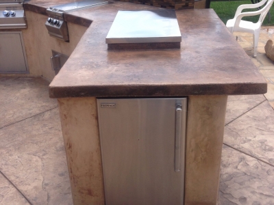 Custom BBQ Grill with concrete countertops and side accessories.