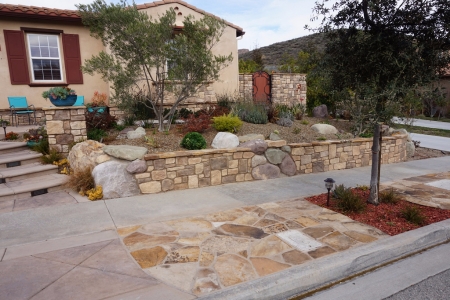 Sidewalk Features with stamped concrete and stone, plus stone retaining wall.