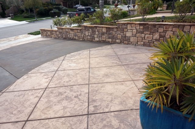 Stone Property Line Wall and Stamped Concrete Driveway