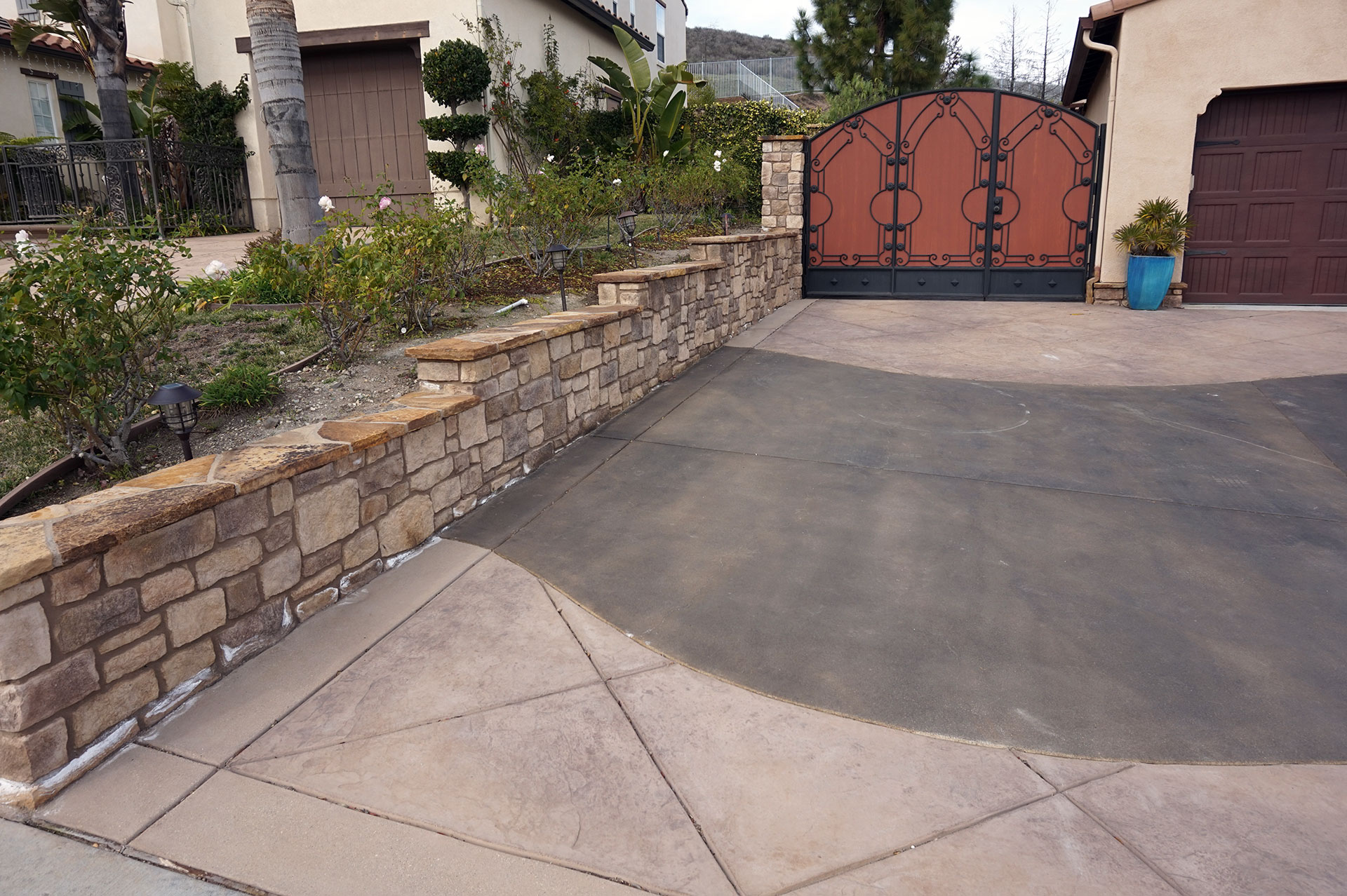 Stone Property Line Wall and Stamped Concrete Driveway Alt View