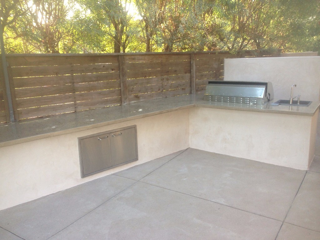 Backyard BBQ setup with custom concrete countertops