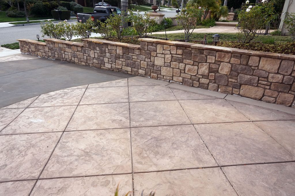 Stone Property Line Wall and Stamped Concrete Driveway alt view 2